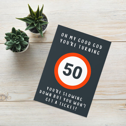 Front of Card, 50th Birthday Design, card on table, with cactus plant in background, card shows a 50 speed sign 