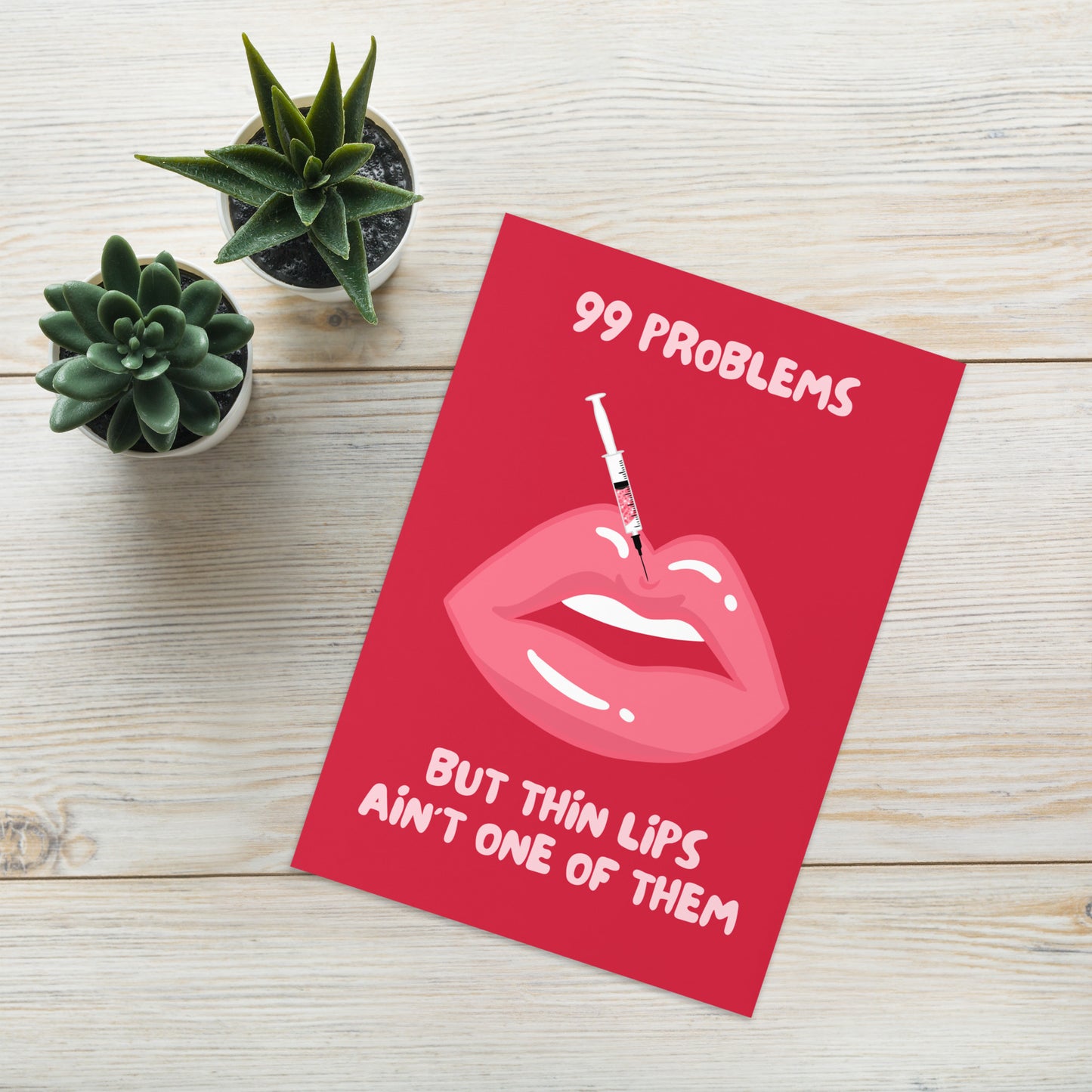 lips card, red background, funny card, silly card, rude card, lying flat on desk with cactus and desk background, lifestyle shot